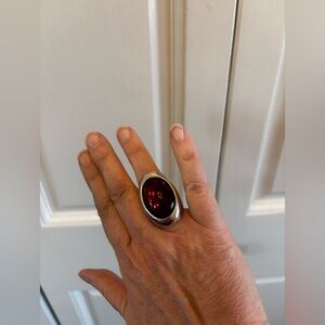 Silver or pewter oxidized ring with a smooth purple/amethyst stone.